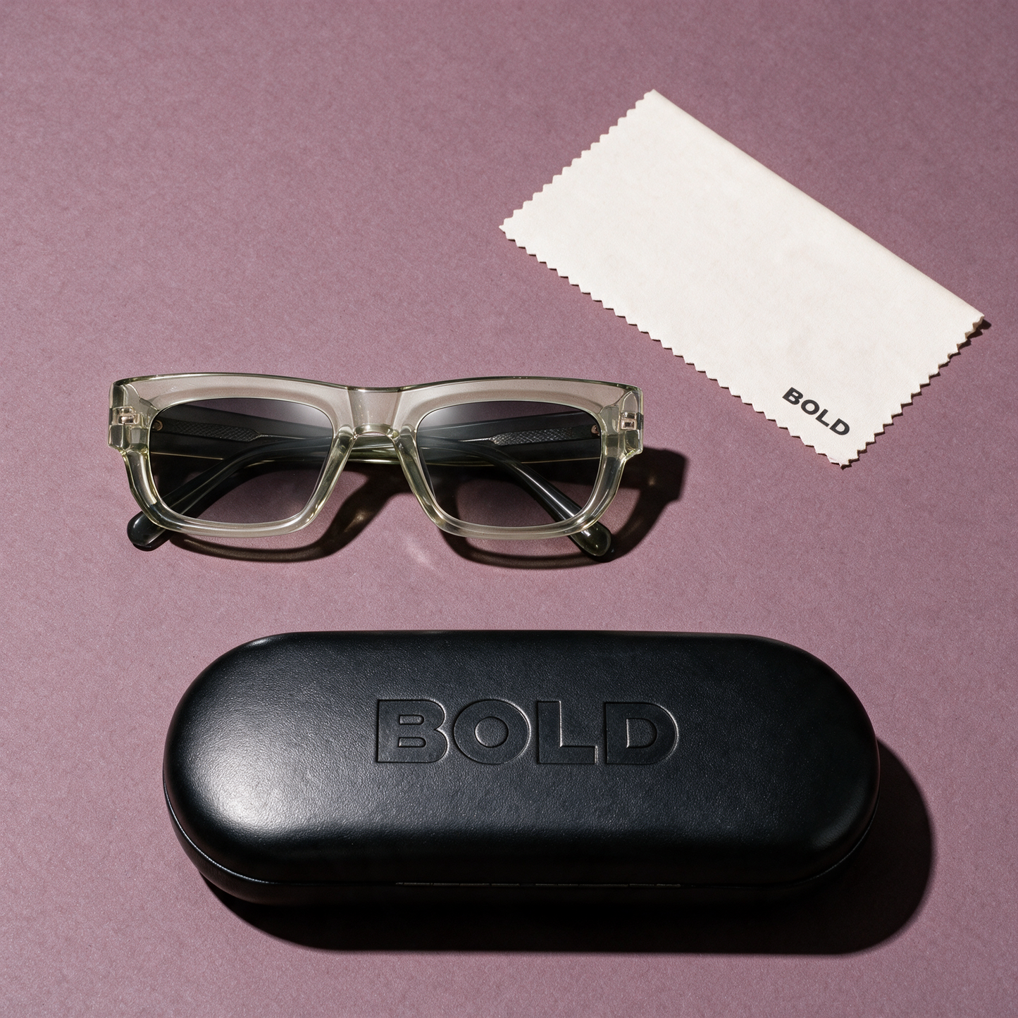 CHISEL Frame 22 sunglasses in CELADON, flat lay with BOLD hard case and cleaning cloth