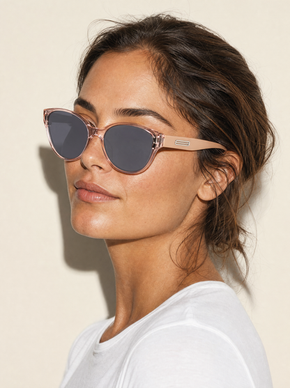 HM578 soft cat-eye sunglasses in BLUSH translucent pink with nude arms, three-quarter portrait