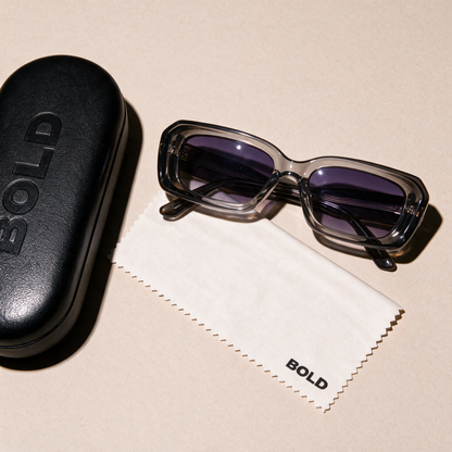 PRISM sunglasses in SLATE, flat lay with case and cloth