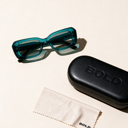PRISM sunglasses in LAGOON, flat lay with case and cloth