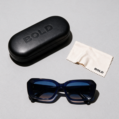 PRISM Frame 18 sunglasses, Cobalt colourway, flat lay with case and cloth