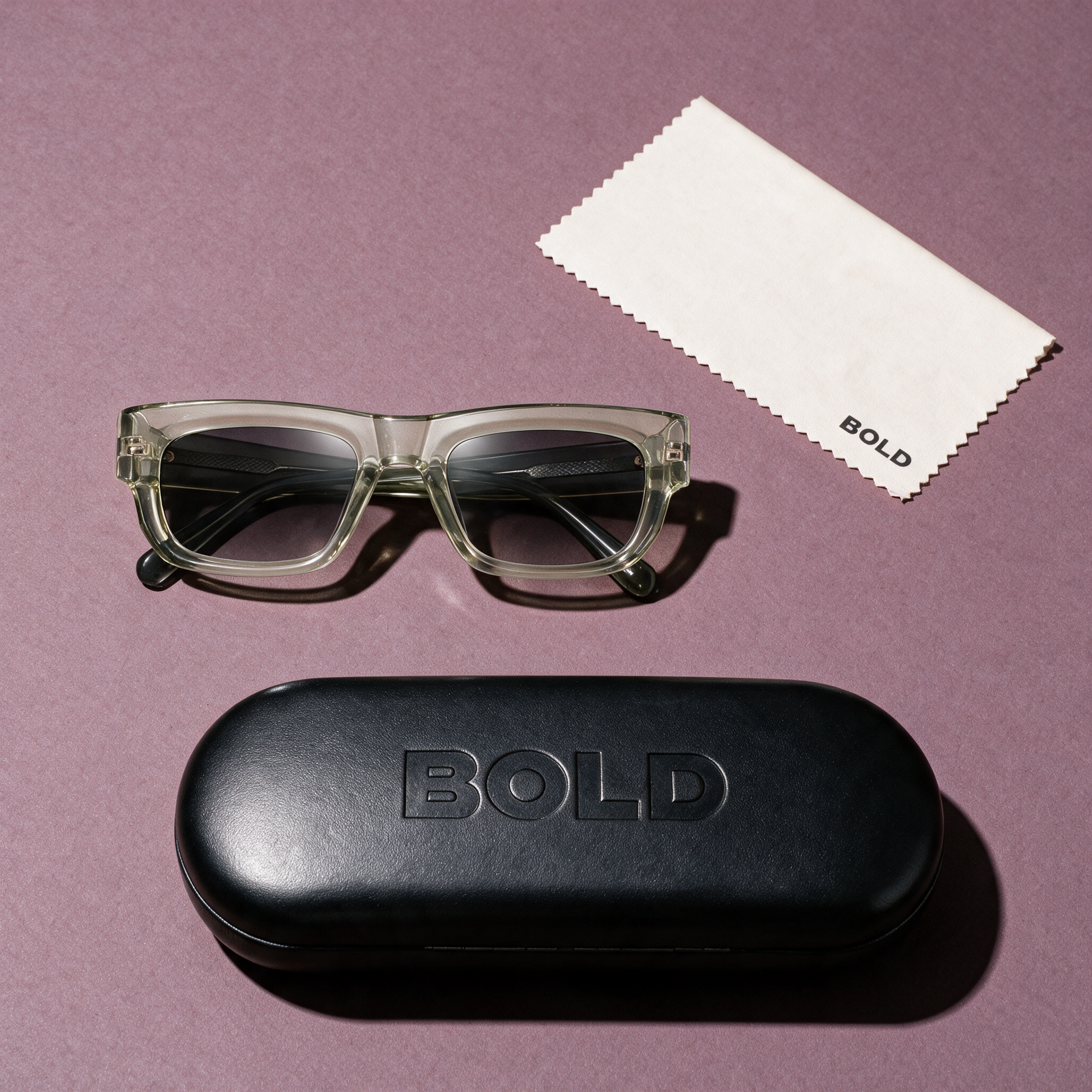 CHISEL Frame 22 sunglasses in CELADON, flat lay with BOLD hard case and cleaning cloth