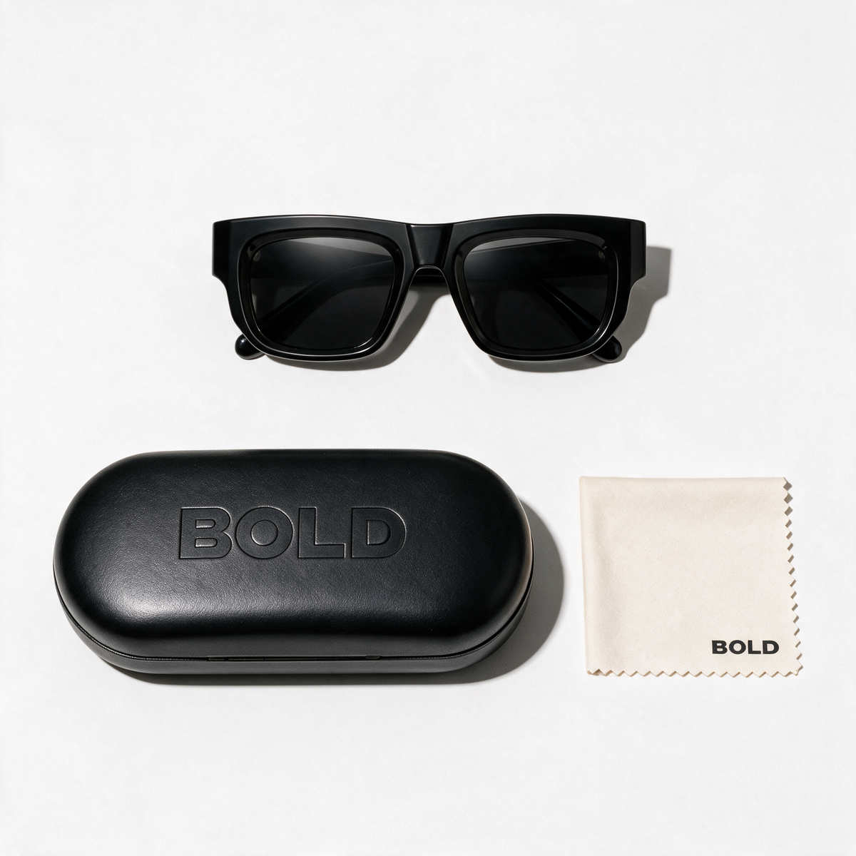CHISEL Frame 22 sunglasses in BASALT, flat lay with BOLD hard case and cleaning cloth
