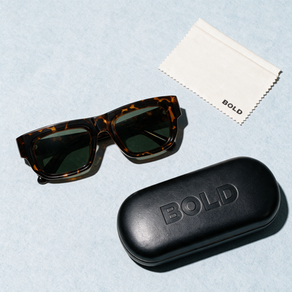 CHISEL Frame 22 sunglasses in CHESTNUT, flat lay with BOLD hard case and cleaning cloth