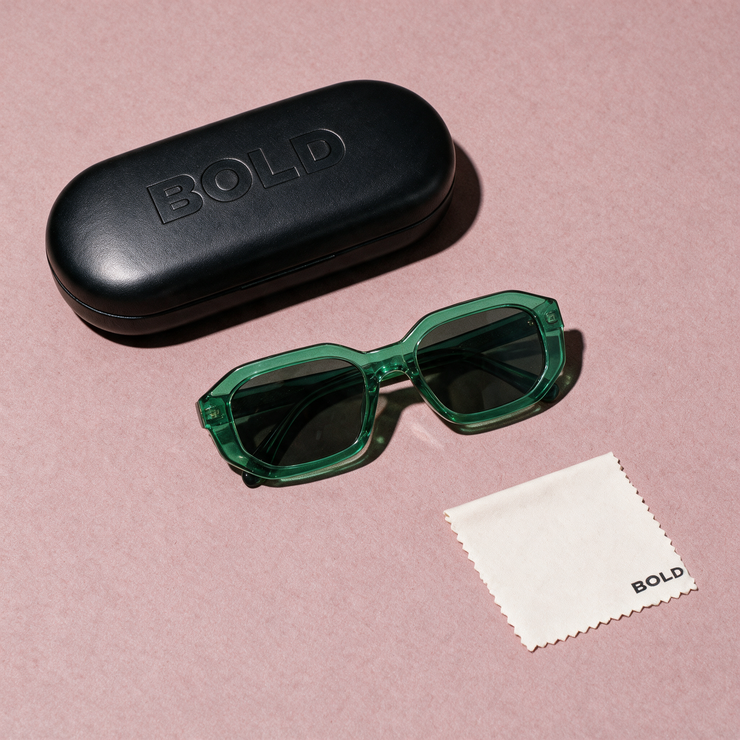 BEVEL EMERALD - flat lay with BOLD hard case and cleaning cloth