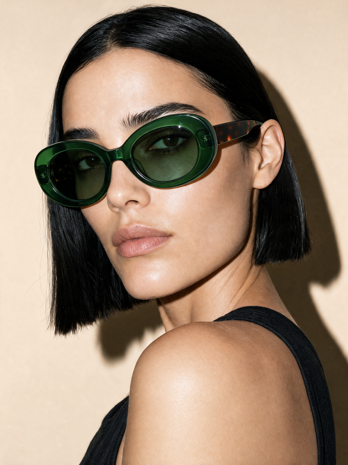 ORBIT Frame 21 oval sunglasses in JUNIPER translucent green with tortoiseshell temples, three-quarter portrait
